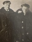 Two Hot Handsome  Men In Long Fur Heavy Coats On Cabinet Photo