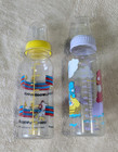 Set Of Two Vintage Baby Bottles - Peanuts  Care Bears From Early 1990s