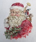 Santa With Toys And Holly Finished Cross Stitch On White Aida Unframed