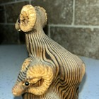 This Image Shows A Hand-carved Wooden Ram Sculpture 