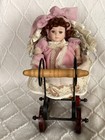 Porcelain Doll With Wicker Carriage