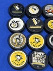 Lot 24 Pittsburgh Penguins Game Souvenir Trench Inglasco Hockey Pucks Nhl
