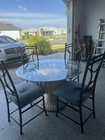 Glass Vintage Table With Four Rod Iron Chairs
