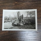 Vintage B w Photo Snapshot Of Couple In Coats Standing On Large Tree In Field