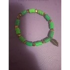 Green Heishi Bead Stretch Bracelet With Gold Star Spacers And Leaf Charm Boho