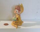 Vintage Golden Sitting Pixie Elf Girl Holding A Cake Bisque ceramic Figurine