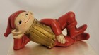 Christmas Elf Pixie Gnome Figurine Red Gold Laying On His Side Chalkware Mache 