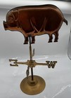 Tabletop Weathervane Featuring A Copper-colored Pig And A Stand-alone Brass Base