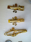 Group Of Vintage Reddy Kilowatt Tie Clips And Pendant