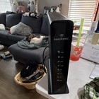 A Black Vertical Panoramic Wifi Gateway  a Combination Cable Modem