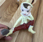 Vintage Yellow And Maroon Ceramic Pixie Elf Figure Sitting Legs Open Mischief