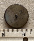 Antique Brass Button With Cicada And Black Wool Fabric Background