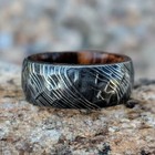 Damascus Steel Wedding Band With Ironwood Sleeve And Hammered Finish