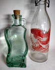 Two  2  Vintage Glass Decorative Bottles Made In Italy And Spain Clear And Green