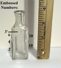 Antique Glass Medicine Bottle With Embossed Measuring Graduations