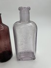 Three  3  Antique Purple Bottles - Two  2  Embossed  bitters   Floor Polish 