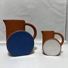 Two Eva Zeisel Terra Cotta And Mate Blue And White  Glazed Schramberg Pitchers