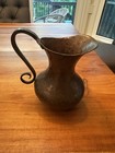 Two Antique Middle Eastern Embossed And Hammered Copper Pitchers