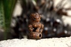 Shishi  foo Dog  Figure With Inlaid Eyes And One Paw Resting On  Decorative Ball