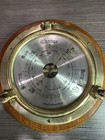 Brass Porthole Barometer On Oak Wood 