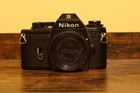 Nikon Em 35mm Slr Film Camera With 24mm F2 8 Quantaray Lens And Two Other Lenses