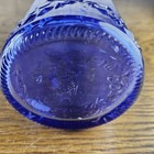 Vintage Cobalt Blue Glass Embossed With Decorative Patterns In A Tall Bottle