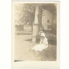 Woman Wearing White Dress And Bonnet Sitting On Front Lawn 1920s Vintage Photo