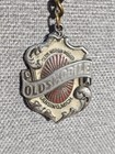 Vintage Souvenir Keychain Featuring The Early Emblem Of Oldsmobile 
