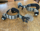 Pair Of Cowboy Spurs Made Of Mixed Metals With One Leather Strap