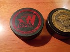 Lot Of 2 Hockey Pucks And Metal Case