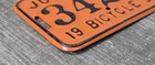 1954 Johnstown Bicycle License Plate  3424 Orange Black Bike Tag