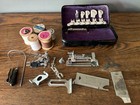 Antique Sewing Machine Attachments And Thread On Wooden Spool