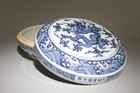 A Blue And White Container With Lid