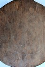 Antique Round Wooden Bread Board Featuring A Paddle Handle And A Hanging Hole