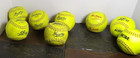 Eight Assorted Yellow Softballs