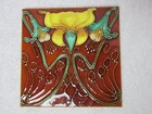 Two Majolica Tiles  Different Yellow Floral Designs  On Green  Burnt Orange