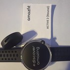 Black Round Sport Gps Smartwatch With Perforated Strap For Wrist