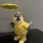 Finch In Yellow Raincoat With Umbrella 