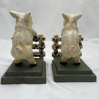 A Pair Of Hand Painted Cast Iron Pig Jumping Over A Fence Book Ends