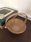 Small Nantucket Style Basket With Swing Handle And Wooden Bottom