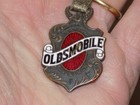 Vintage Oldsmobile Embossed Enamel Watch Fob With Leather Strap