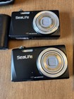2 Sealife Dc1400 Cameras  2 Underwater Housing  5 Batteries  Chargers  Pro Flash