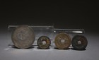 A Set Of One Silver Coin And Three Bronze Coins