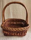 A Vintage Wicker Basket With A Wooden Handle And Decorative Wooden Beads 