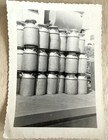 Vintage Snapshot Photo Abstract 1950s Metal Milk Canisters Stacked On Truck