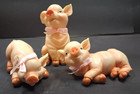 Three Resin Pigs With Pink Bows