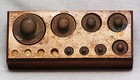 Antique Set Of Seven Brass Balance Scale Weights   With Wood Holder