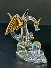 Glass Dragon Figurine With Golden Accents And A Multi-faceted Crystal Ball