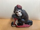 Vintage Cast Iron Monkey With Red Pill Box Hat On Red Scooter 