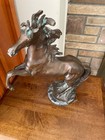 Bronze Horse On Marple Platform On Hind Legs With Large Mane Of Beautiful Bronze